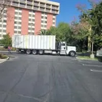 Truck transporting a large container on a city road